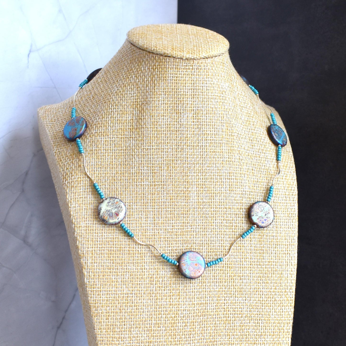 Marbled discs and twisted silver necklace
