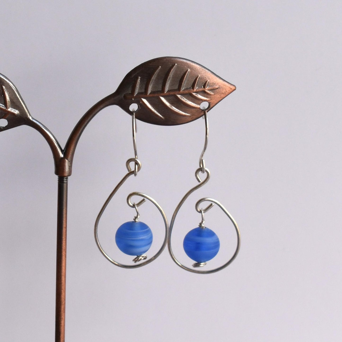 Silver wire motif earrings with coloured bead