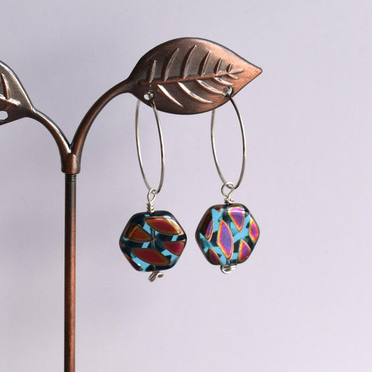 Silver hoop earrings with blue hexagon bead drop