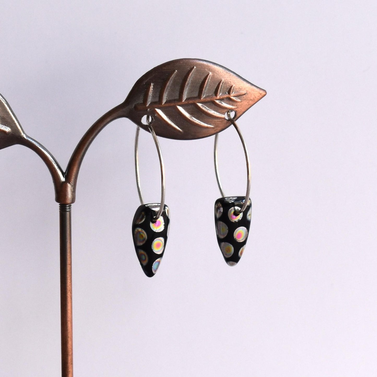 Silver hoop earrings with black cone bead drop
