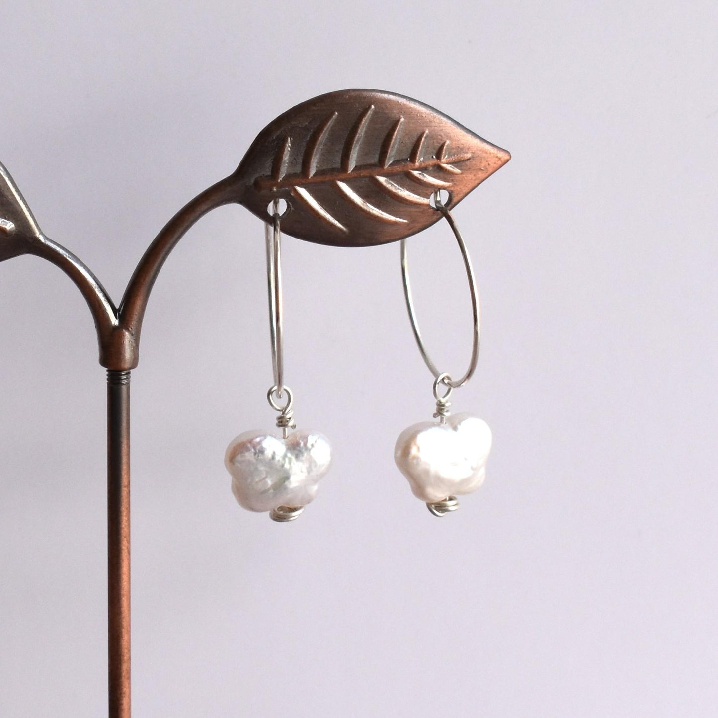 Silver hoop earrings with butterfly-style freshwater pearl