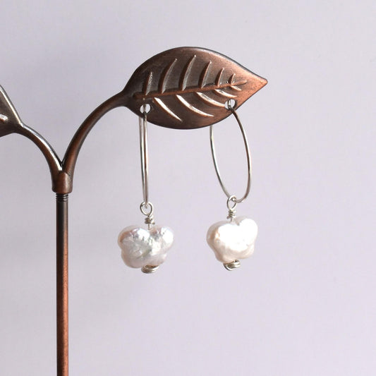 Silver hoop earrings with butterfly-style freshwater pearl